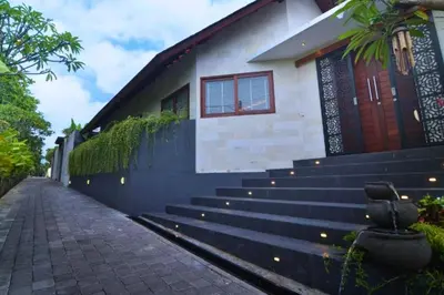 a house with stairs in front of a building at Kamila Aranne 3 BR Private Pool Villa in Jimbaran
