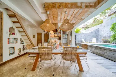a dining room with a table and chairs and a pool at New Listing 1 BD Vintage Charm in Central Berawa in Canggu