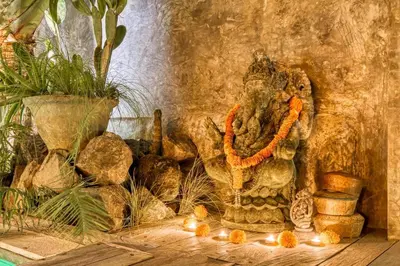a statue of an elephant sitting next to some rocks at New Listing 1 BD Vintage Charm in Central Berawa in Canggu