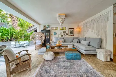 a living room with a couch and a table at New Listing 1 BD Vintage Charm in Central Berawa in Canggu