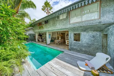 a house with a swimming pool in the backyard at New Listing 1 BD Vintage Charm in Central Berawa in Canggu
