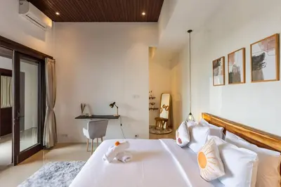 a bedroom with a large white bed with white pillows at Comfy 3bd Family Villa with Private Pool in Central Location in Kerobokan