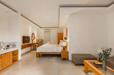 a large room with a bed and a kitchen at Stylish 1 Bd Pvt Apartment w shared kitchen and pool in Seminyak