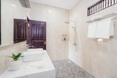 a white bathroom with a sink and a shower at Villa Crystal 9b in Seminyak
