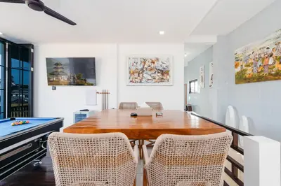 a dining room with a table and a pool table at Villa Crystal 9b in Seminyak