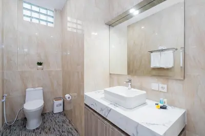 a bathroom with a white sink and a toilet at Villa Crystal 9b in Seminyak
