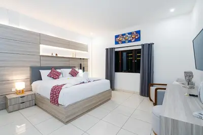 a bedroom with a large bed and a television at Villa Crystal 9b in Seminyak