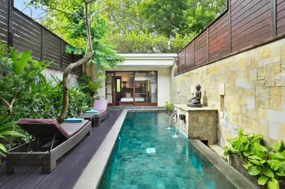 a swimming pool in the middle of a house at Ari Ayra 1 BR Private Pool Villa in Jimbaran