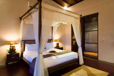a bedroom with a bed with a canopy at Dean 2 BR Private Pool Villa in Jimbaran