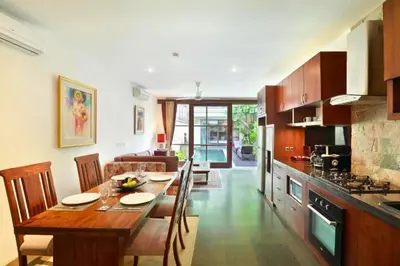 a kitchen and dining room with a table and chairs at Dean 2 BR Private Pool Villa in Jimbaran