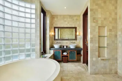 a large bathroom with two sinks and a tub at Dean 2 BR Private Pool Villa in Jimbaran