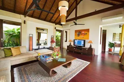 a living room with a couch and a coffee table at Azarina 3 BR Private Pool Villa in Jimbaran