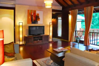 a living room with a couch and a television at Azarina 3 BR Private Pool Villa in Jimbaran