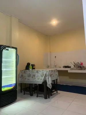 a kitchen with a table in the middle of a room at Conscious House near Kuta and Seminyak in Legian