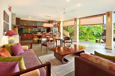 a living room with a couch and a table at Dendalion 4 BR Private Pool Villa in Jimbaran