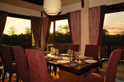 a dining room table with wine glasses on it at Dendalion 4 BR Private Pool Villa in Jimbaran