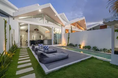 a house with a swimming pool in the backyard at Sea Breeze Retreat Modern 3BR Villas in Canggu in Canggu