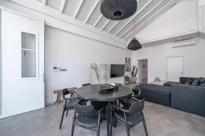 a living room with a table and a couch at Sea Breeze Retreat Modern 3BR Villas in Canggu in Canggu