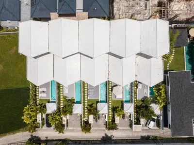an overhead view of a white building with trees at Sea Breeze Retreat Modern 3BR Villas in Canggu in Canggu