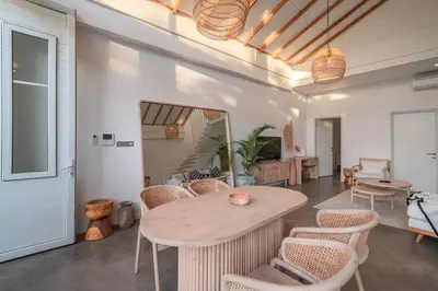 a living room with a table and chairs at Sea Breeze Retreat Modern 3BR Villas in Canggu in Canggu