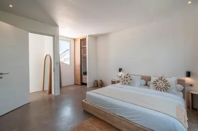 a white bedroom with a large bed in it at Sea Breeze Retreat Modern 3BR Villas in Canggu in Canggu