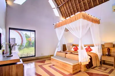 a bedroom with a bed with a canopy at Cozy Executive 2 BR Pool Villa in Seminyak