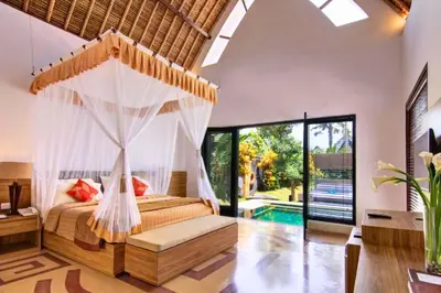 a bedroom with a bed with a hammock in it at Cozy Executive 2 BR Pool Villa in Seminyak