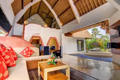 an open living room with a couch and a table at Cozy Executive 2 BR Pool Villa in Seminyak