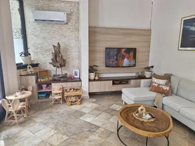 a living room with a couch and a table at Langikula Villa Seminyak Bali in Seminyak
