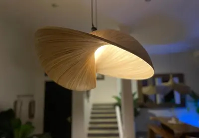 a light hanging from a ceiling in a living room at Langikula Villa Seminyak Bali in Seminyak