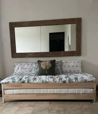 a large mirror above a couch in a room at Langikula Villa Seminyak Bali in Seminyak
