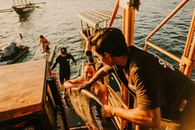 a group of people on a boat in the water at Floating Hotel SALTWATER COWBOYS in Kuta