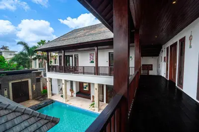 an external view of a house with a swimming pool at The Golden Serendipity Villa Seminyak in Seminyak