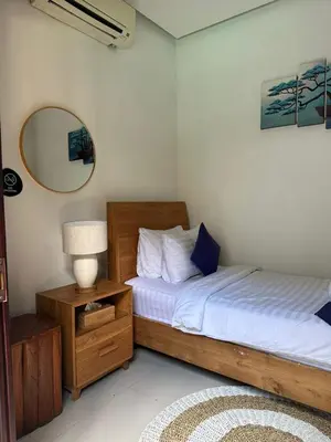 a bedroom with two twin beds and a mirror at The Golden Serendipity Villa Seminyak in Seminyak
