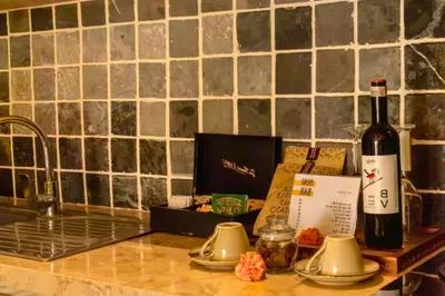 a bottle of wine sitting on a counter next to a sink at Sweet 3 BR Private Pool Villa Garden View in Kerobokan