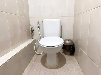 a bathroom with a white toilet in a stall at Cosy 3 bedrooms at budget price @ Jimbaran in Jimbaran