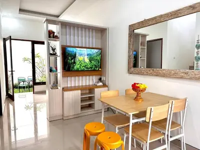 a dining room with a table and a mirror at Cosy 3 bedrooms at budget price @ Jimbaran in Jimbaran