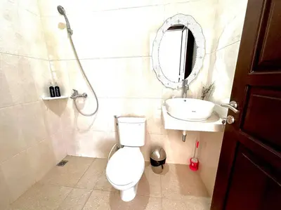 a bathroom with a toilet and a sink and a mirror at Cosy 3 bedrooms at budget price @ Jimbaran in Jimbaran