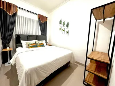 a bedroom with a white bed and a mirror at Cosy 3 bedrooms at budget price @ Jimbaran in Jimbaran