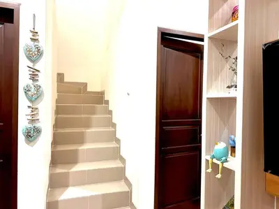 a stairway leading to a room with a stair case at Cosy 3 bedrooms at budget price @ Jimbaran in Jimbaran