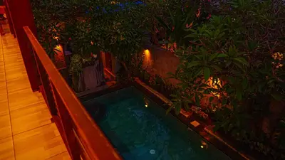 an indoor jacuzzi tub in a balcony with plants at Dirga's House Sanur View by EPS in Sanur