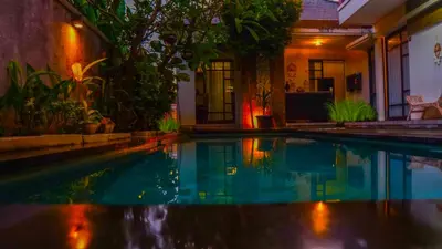 a swimming pool in the middle of a house at Dirga's House Sanur View by EPS in Sanur