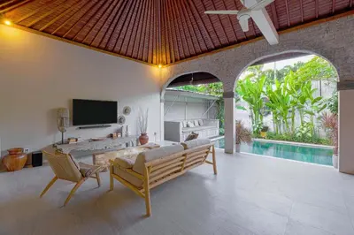 a living room with a couch and a tv at VILLA LA FELICITA in Seminyak