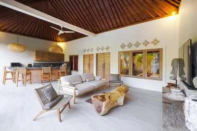 a living room with a couch and a table at VILLA LA FELICITA in Seminyak