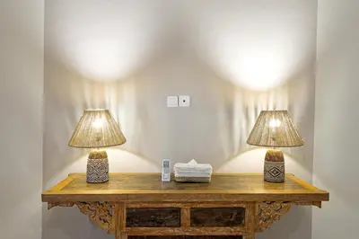 two lamps on top of a wooden table at VILLA LA FELICITA in Seminyak