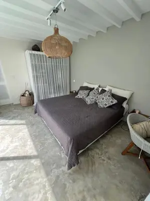 a bedroom with a bed in a white room at Lovely 3 BR villa with private pool in Canggu