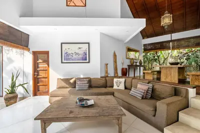 a living room with a couch and a table at Sahaja Villa by Betterplace in Canggu
