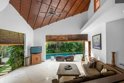 a living room with a couch and a table at Sahaja Villa by Betterplace in Canggu