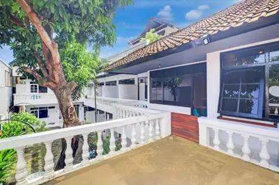 a balcony of a house with a tree at Collection O at Jalan Padma near Legian Beach in Legian