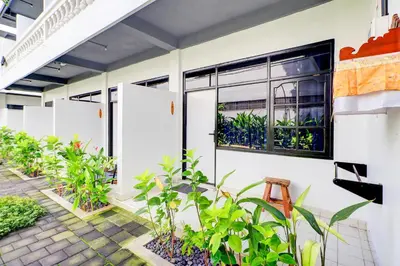 a building with plants in front of a window at Collection O at Jalan Padma near Legian Beach in Legian